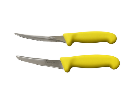 a pair of yellow handled knives on a black background
