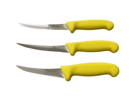 three knives with yellow handles on a black background