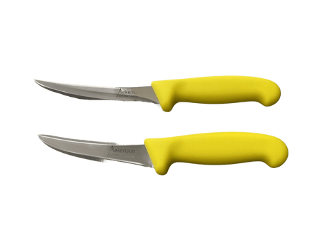 a pair of yellow handled knives on a black background