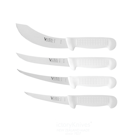 a set of four knives sitting next to each other