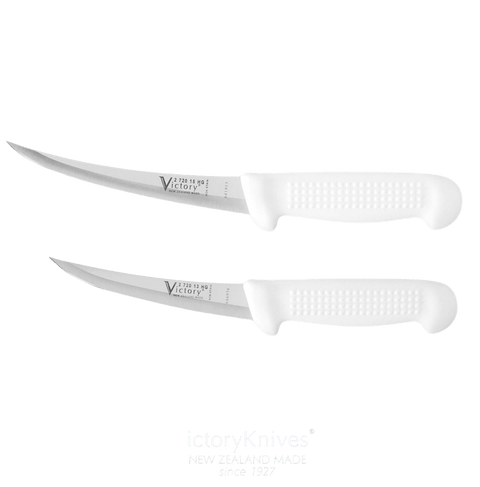 a pair of white knives sitting next to each other
