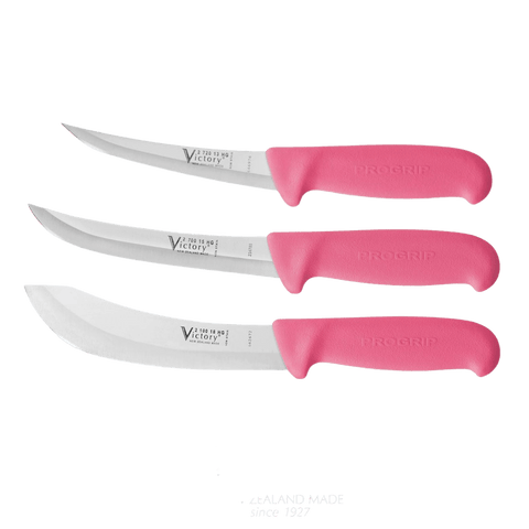 a set of three knives with pink handles